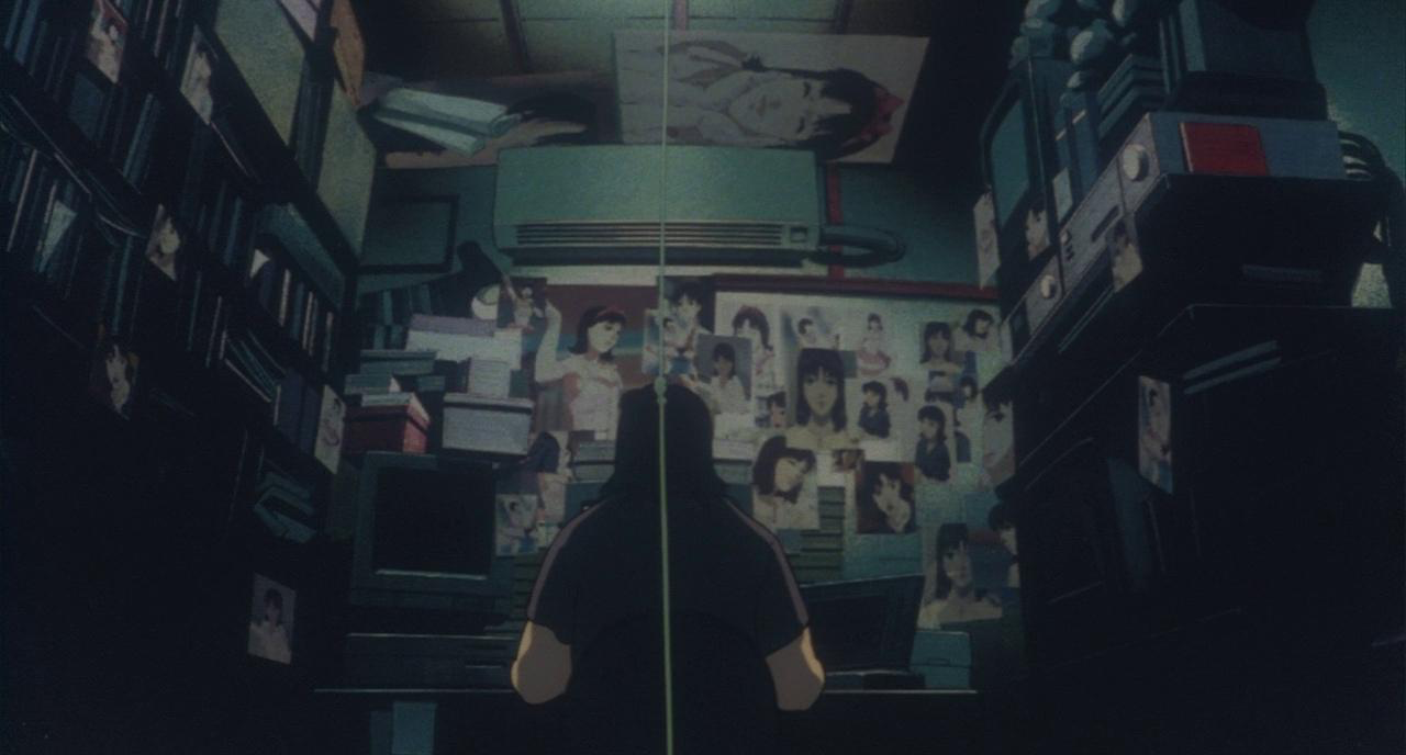A man with images of Mima around the room he's in